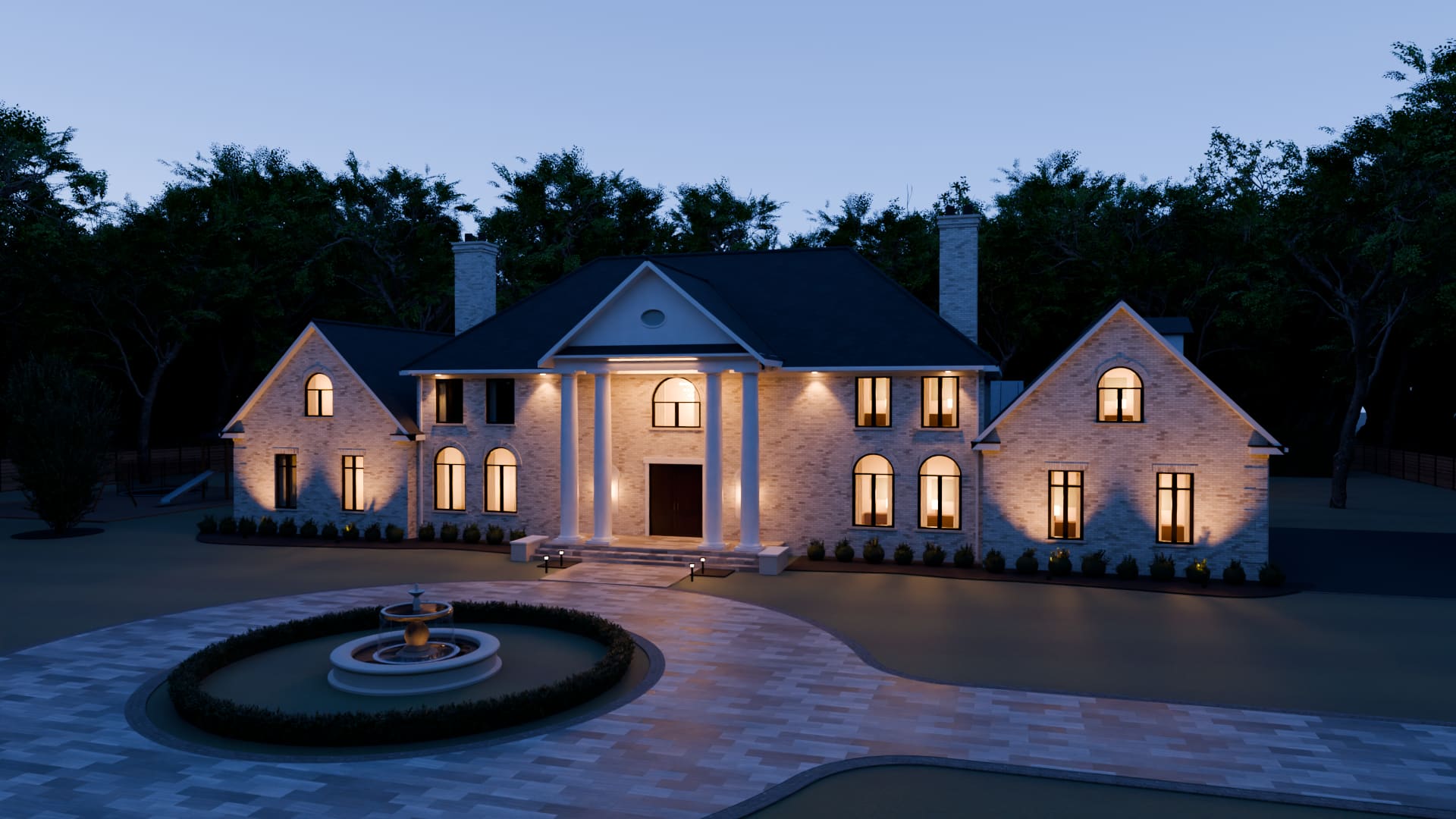 The Traditional House at dusk from the lawn: windows lit, the brass rings of the hall showing in the window over the doors, the portico and the wing gables washed with light against a deep blue sky.